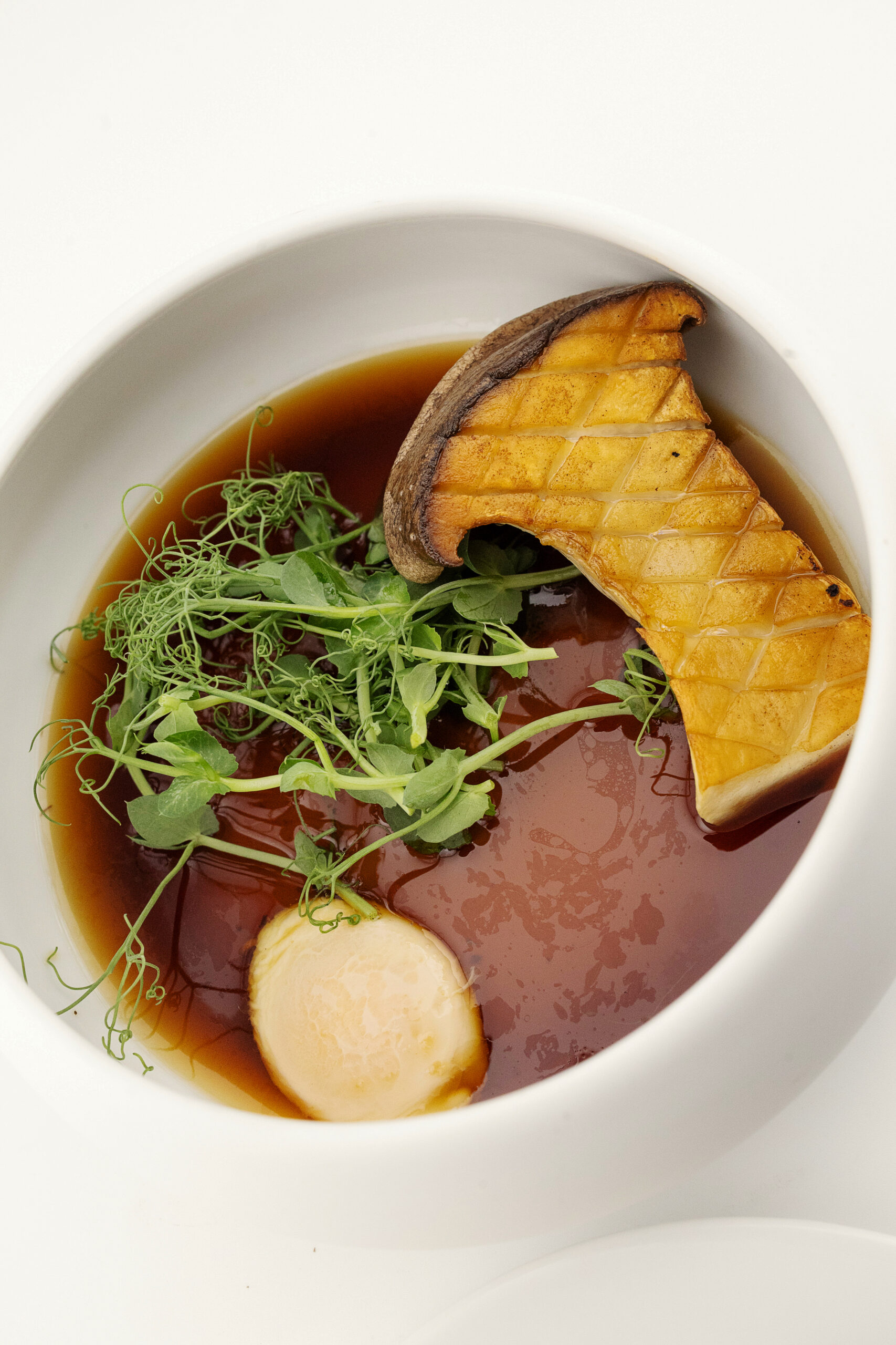 King trumpet mushroom and quail egg in mushroom broth