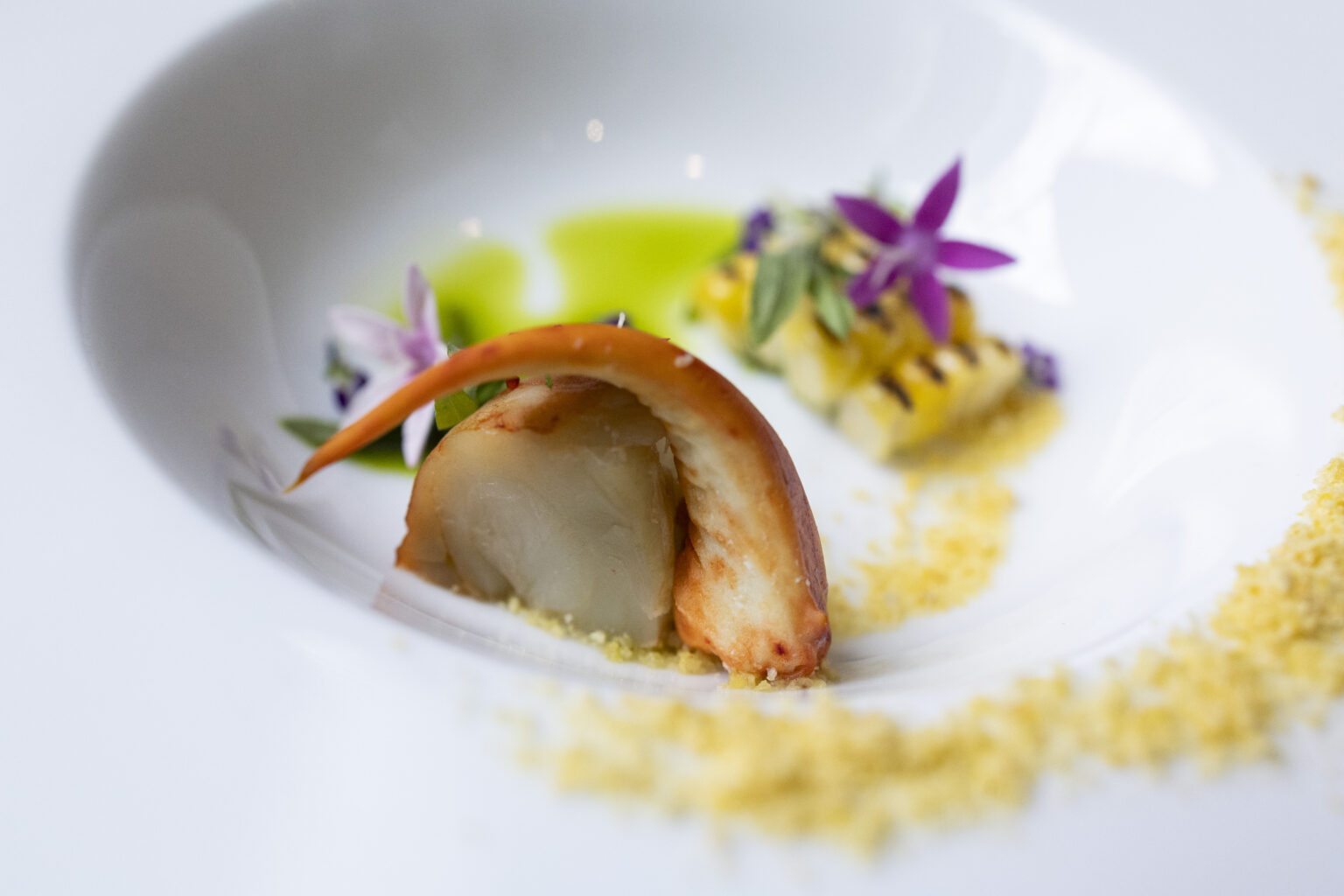 Lobster with flowers in a white bowl