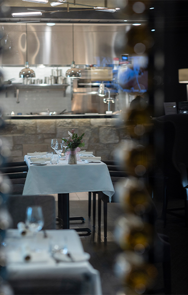 A table set beside the open kitchen at Opus